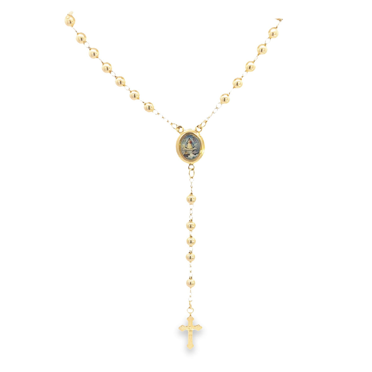 A polished gold rosary necklace hangs against a white background, featuring round gold beads, an oval centerpiece, and a delicate cross pendant.