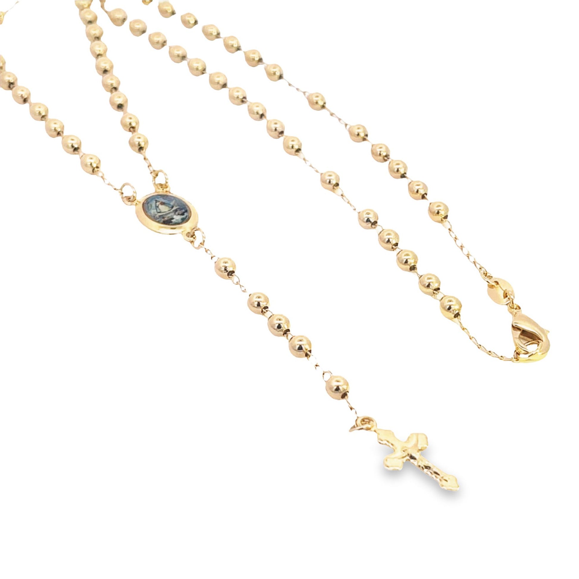 A delicate gold rosary necklace features polished bead stations, a small religious medallion, and a dangling crucifix.