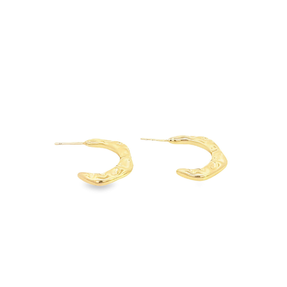 A pair of textured gold hoop earrings rests on a clean white surface.