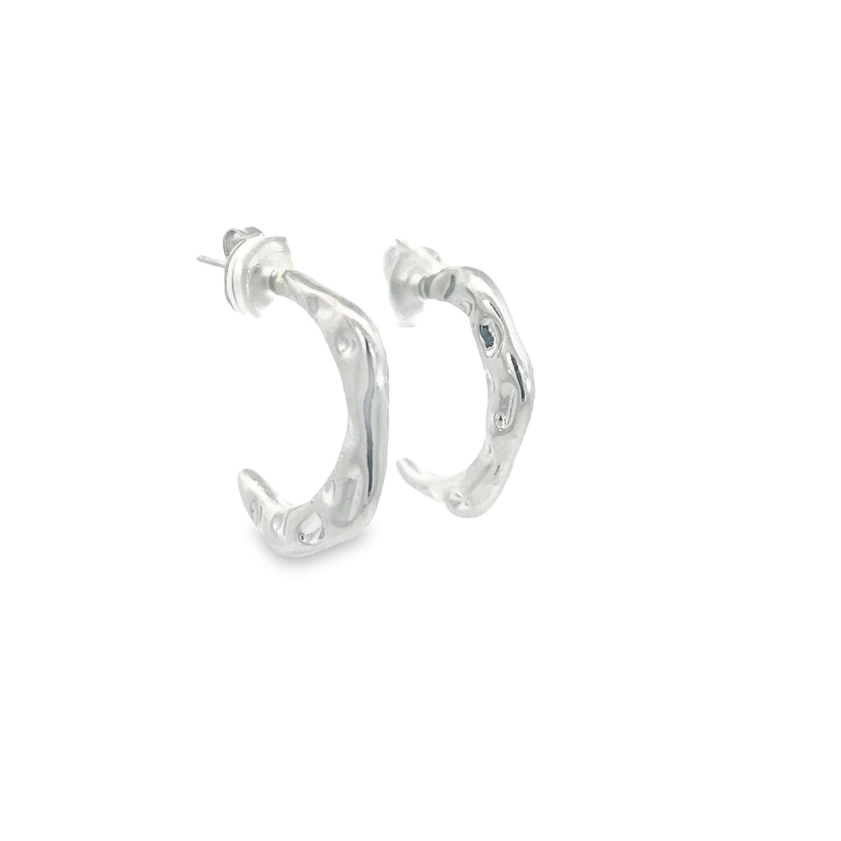 A pair of silver textured hoop earrings rest against a clean white background.