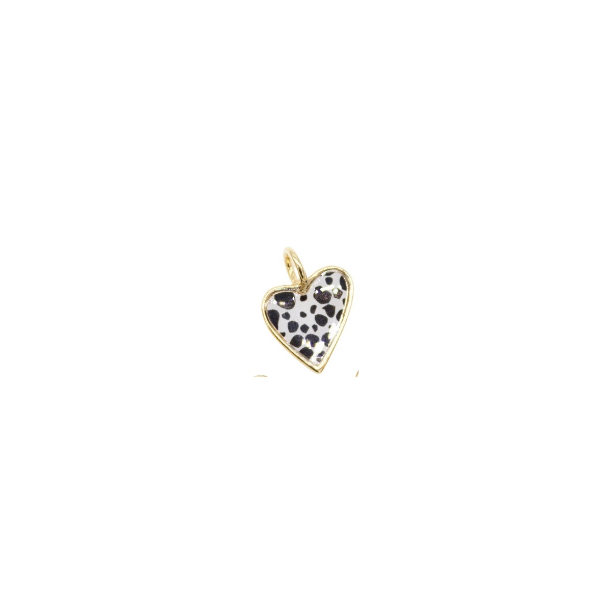A gold-rimmed heart charm features a playful black-and-white dalmatian print against a clean white background.