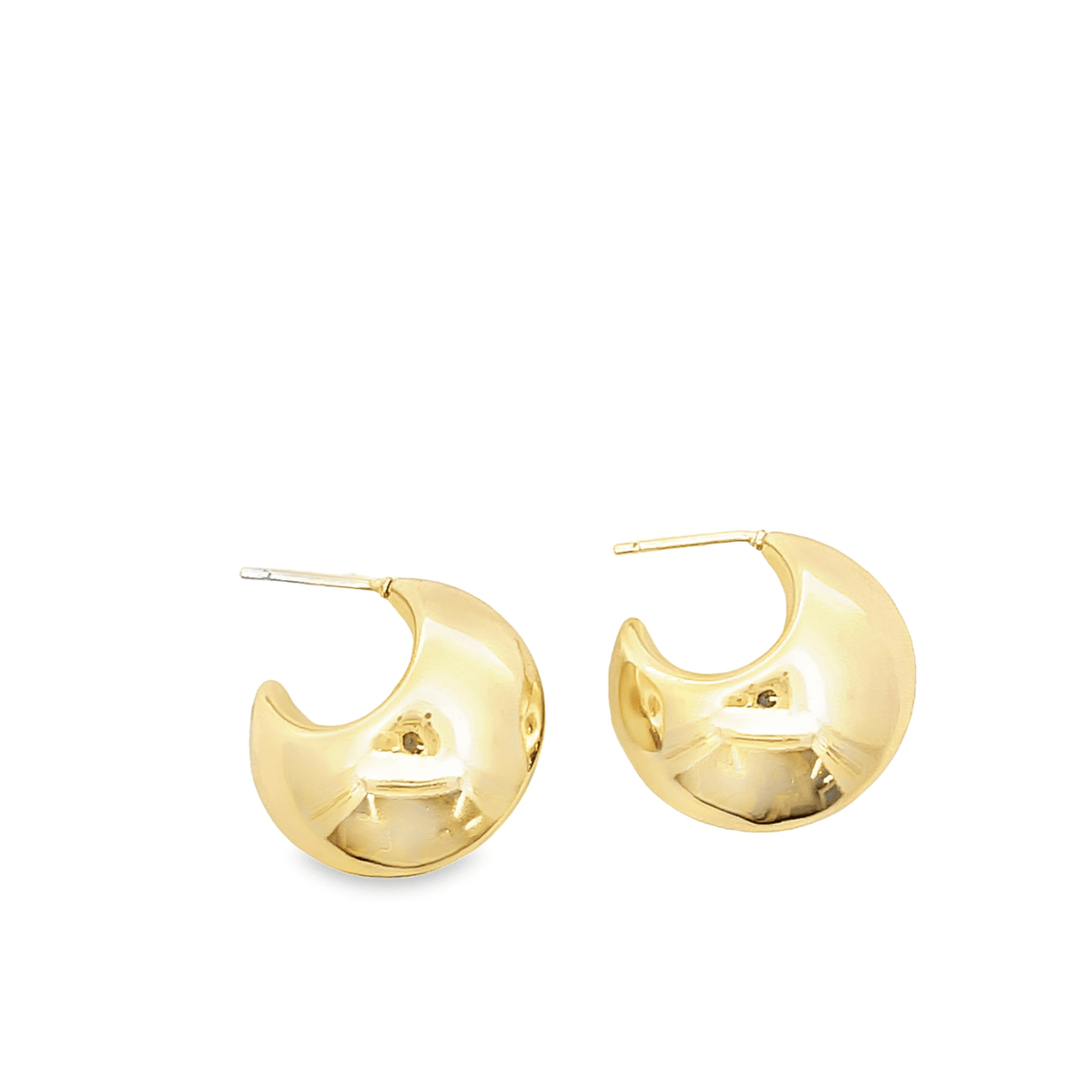 A pair of shiny, thick gold hoop earrings rests against a clean white background.