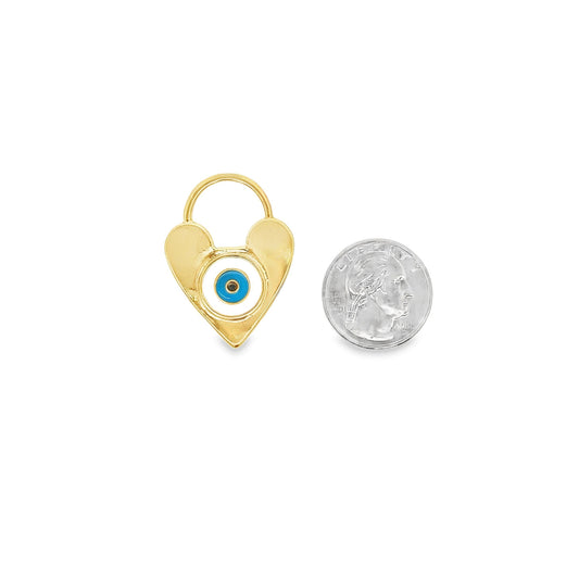 A gold heart-shaped charm featuring a blue and white evil eye design sits next to a US quarter for scale.