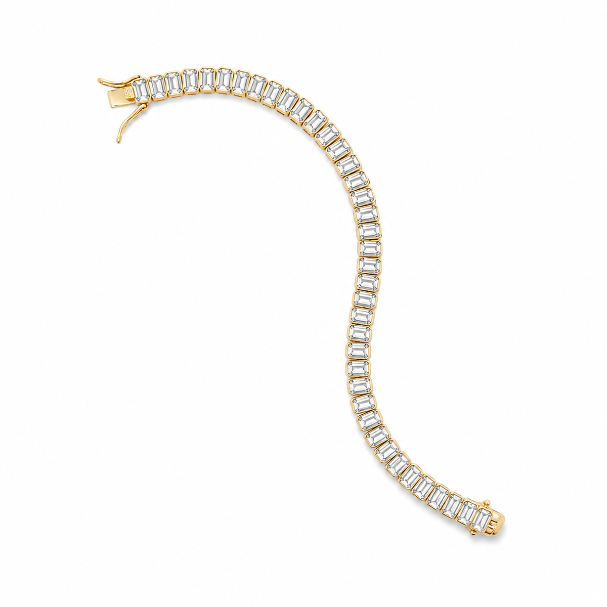A gold tennis bracelet curves gracefully on a white background, featuring a continuous line of sparkling emerald-cut diamonds in prong settings.