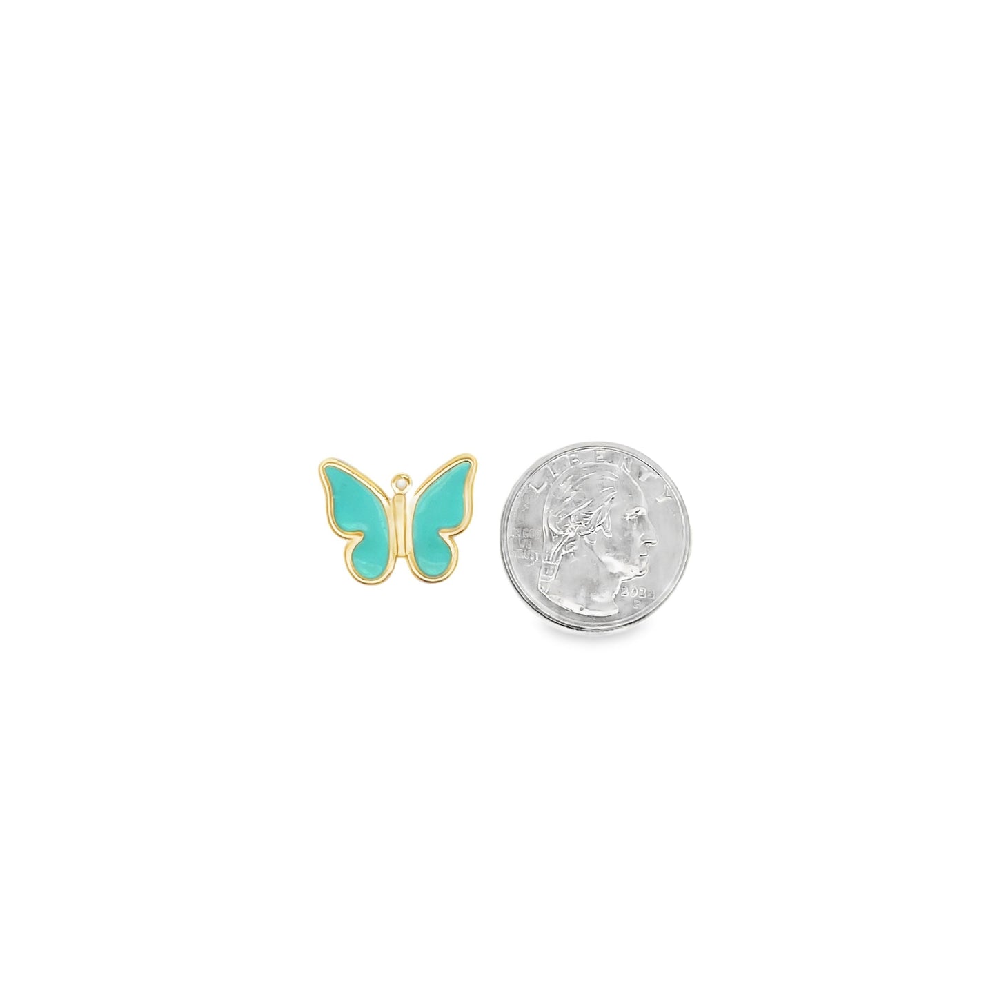 A small gold and turquoise enamel butterfly pendant rests next to a US quarter coin to show scale.