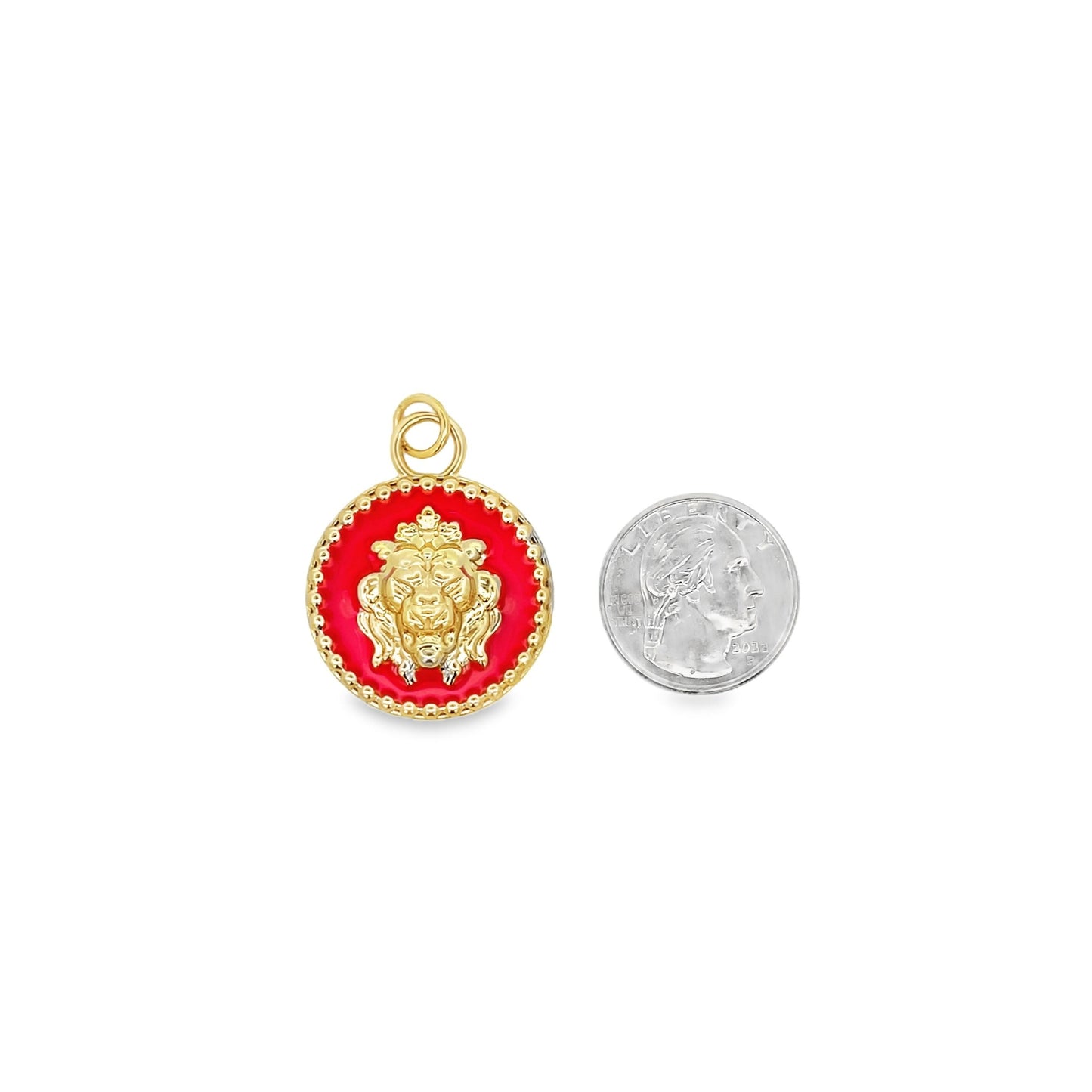 A gold and red enameled lion pendant sits next to a US quarter coin to show its scale.