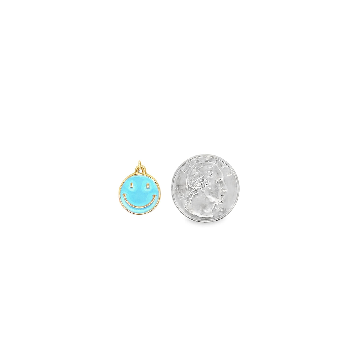A blue enamel smiley face charm rests next to a US quarter coin for size comparison.