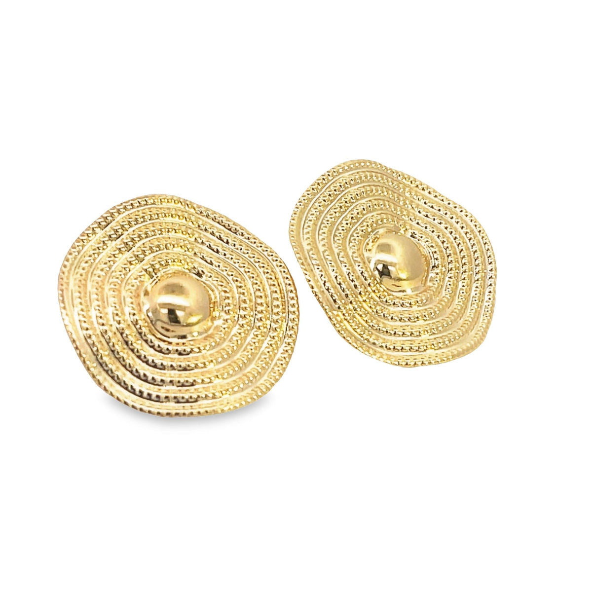 A pair of textured gold stud earrings display concentric oval patterns centering on a polished dome.