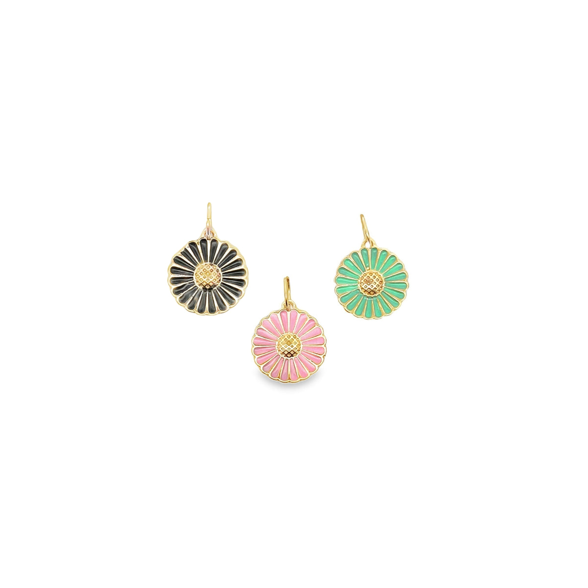Three gold enamel daisy charms in black, pink, and green lie against a white background.