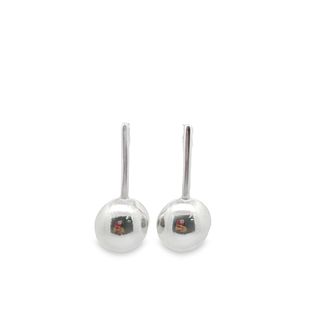 A pair of polished silver drop earrings featuring sleek vertical posts and smooth, rounded ball pendants stand against a clean white background.