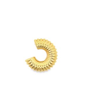 A textured gold croissant ear cuff sits isolated against a clean white background.