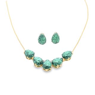 A matching gold jewelry set features pear-shaped green turquoise stones arranged in a necklace and earrings.