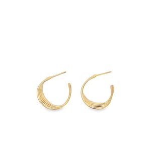 A pair of elegant gold crescent-shaped hoop earrings rests against a clean white background.