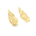 A pair of abstract gold-plated statement earrings features a fluid, melted metal design against a clean white background.