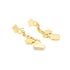 A pair of dangling gold geometric earrings resting on a white surface.