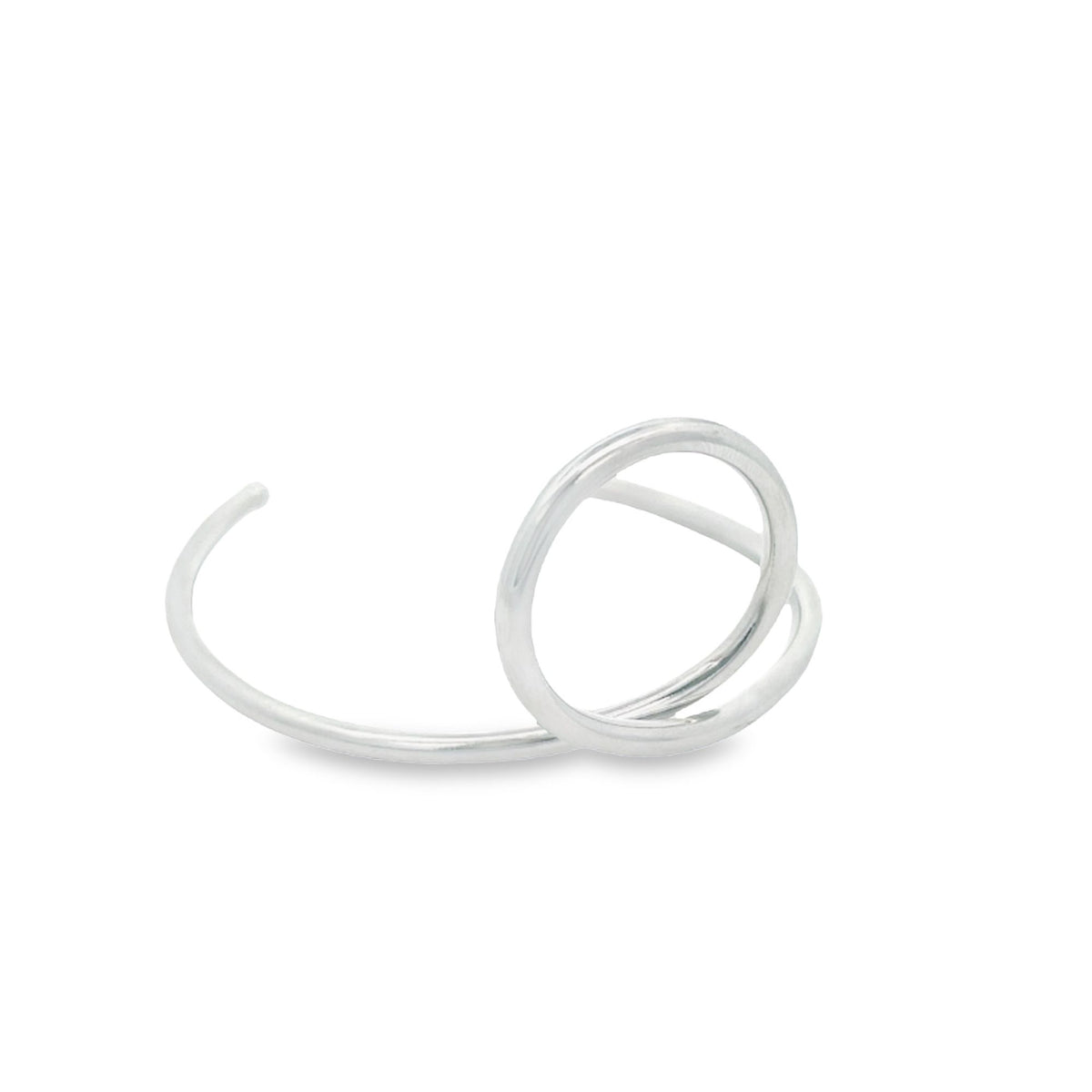 A modern silver cuff bracelet features a unique sculptural ring design against a clean white background.