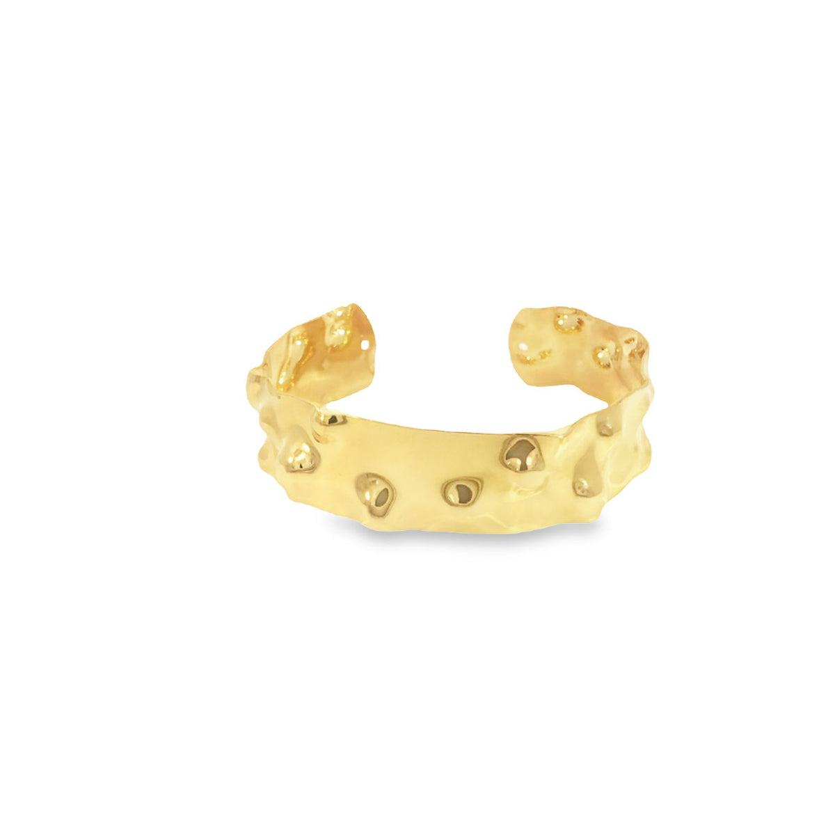 A thick gold cuff ring features an uneven, hammered texture with rounded indentations and a polished finish against a white background.