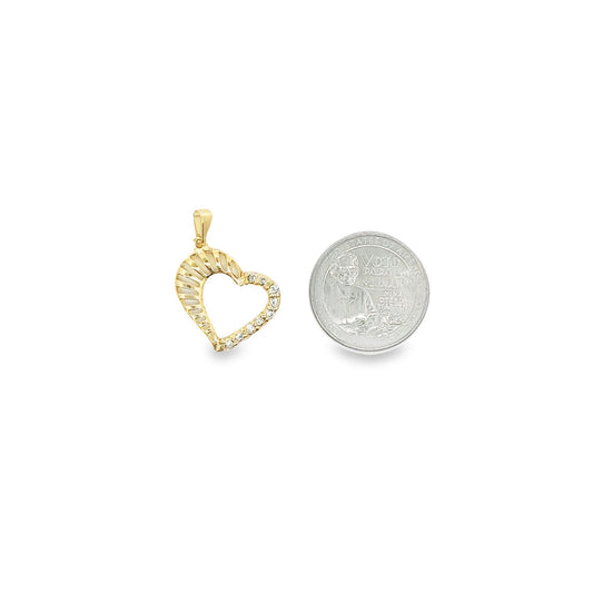 A gold heart pendant with sparkling cubic zirconia stones sits next to a US quarter coin for size comparison.