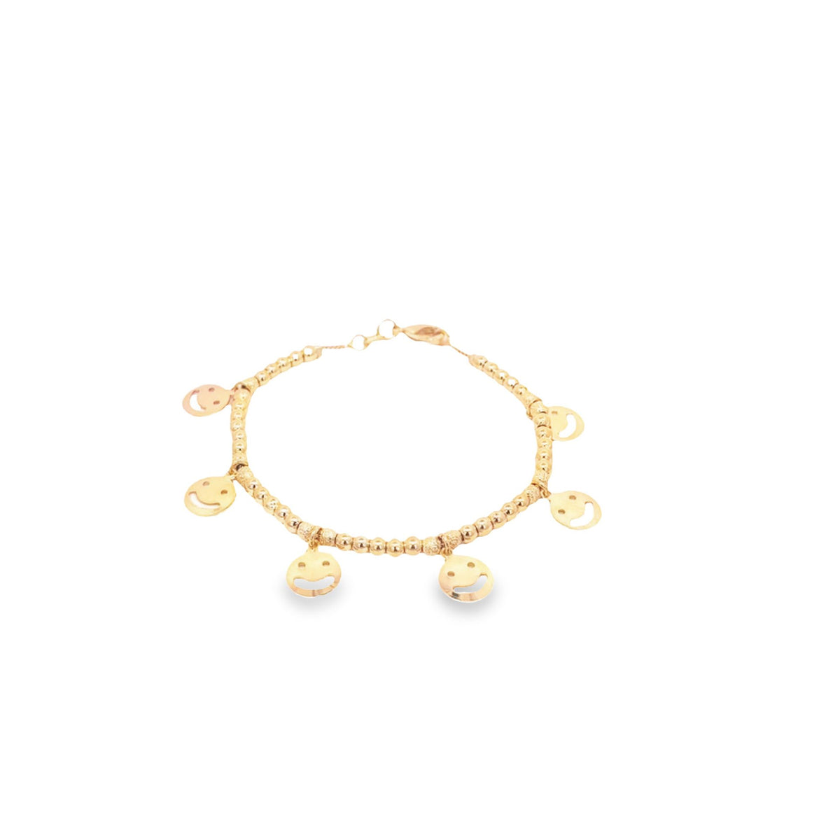 A delicate gold charm bracelet displays multiple smiling face charms along a beaded chain against a white background.