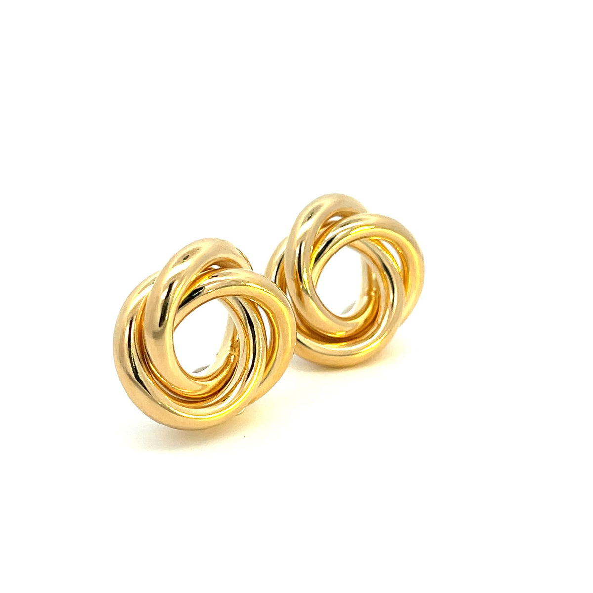 A pair of polished gold love knot earrings sit against a clean white background.