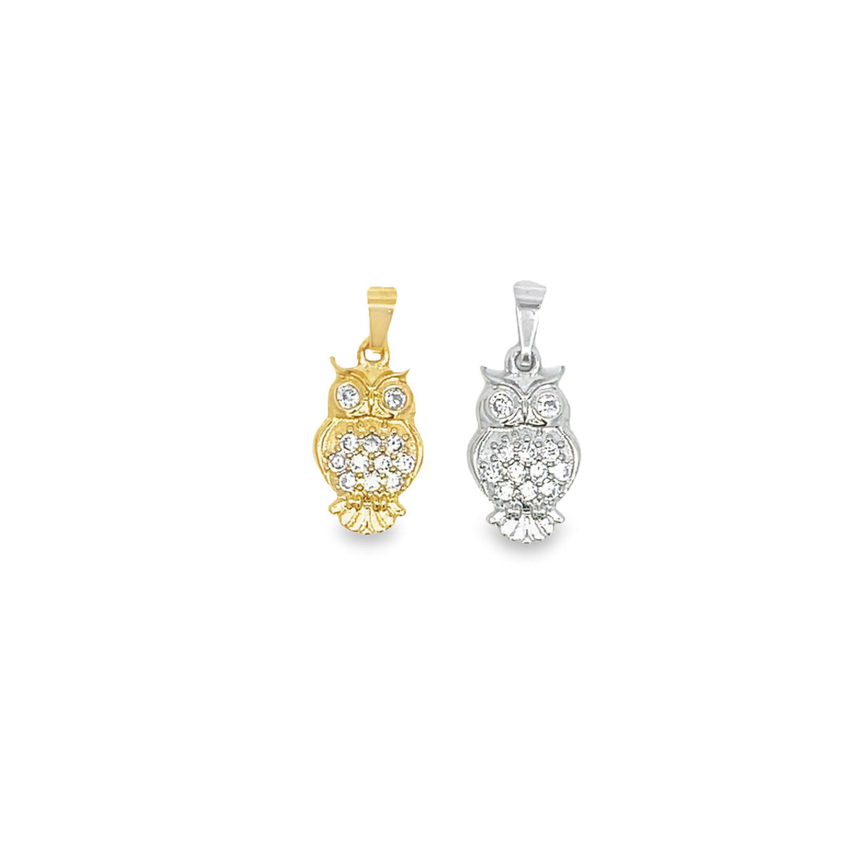 Two sparkling diamond-studded owl pendants, one in yellow gold and the other in silver, rest side by side against a clean white background.