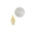 A small gold owl pendant rests beside a quarter to demonstrate its size.