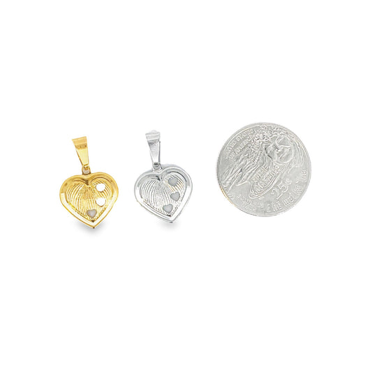 A gold heart pendant and a silver heart pendant featuring fingerprint textures and three small heart accents are displayed alongside a quarter coin for size comparison.