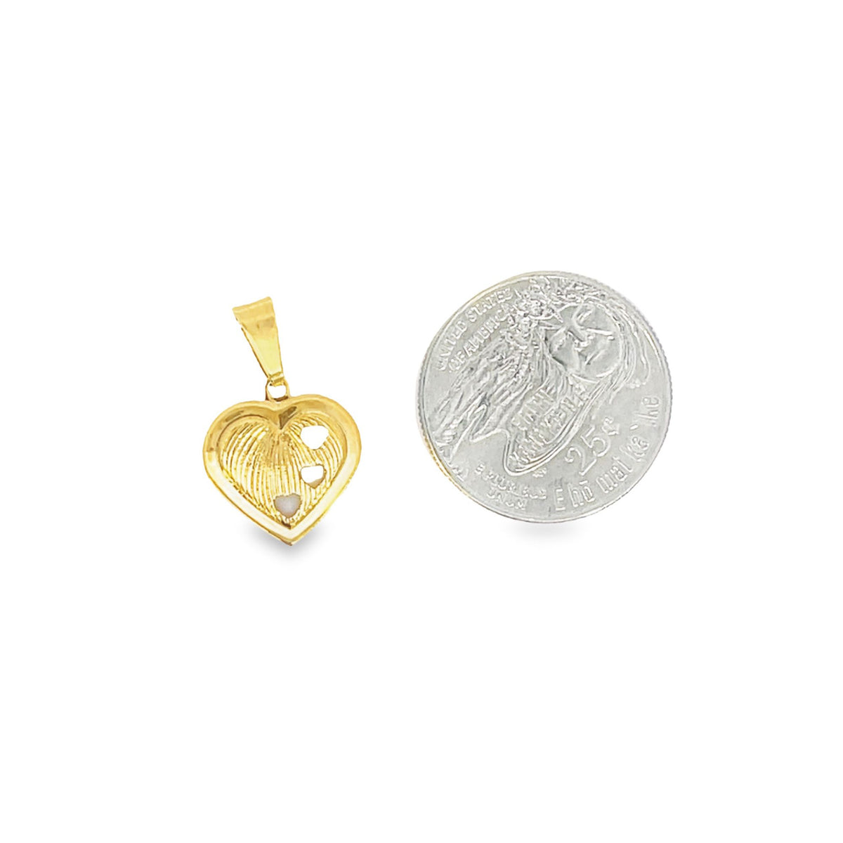 A gold heart-shaped pendant rests next to a US quarter coin to show scale.