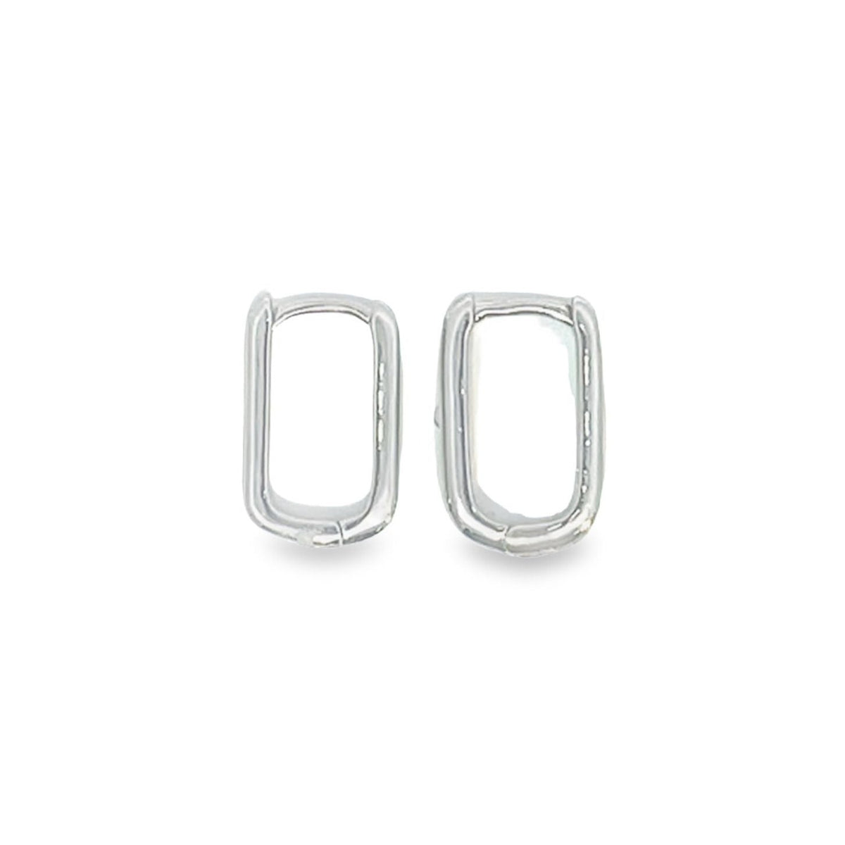 A pair of minimalist silver rectangular huggie hoop earrings rests against a clean white background.