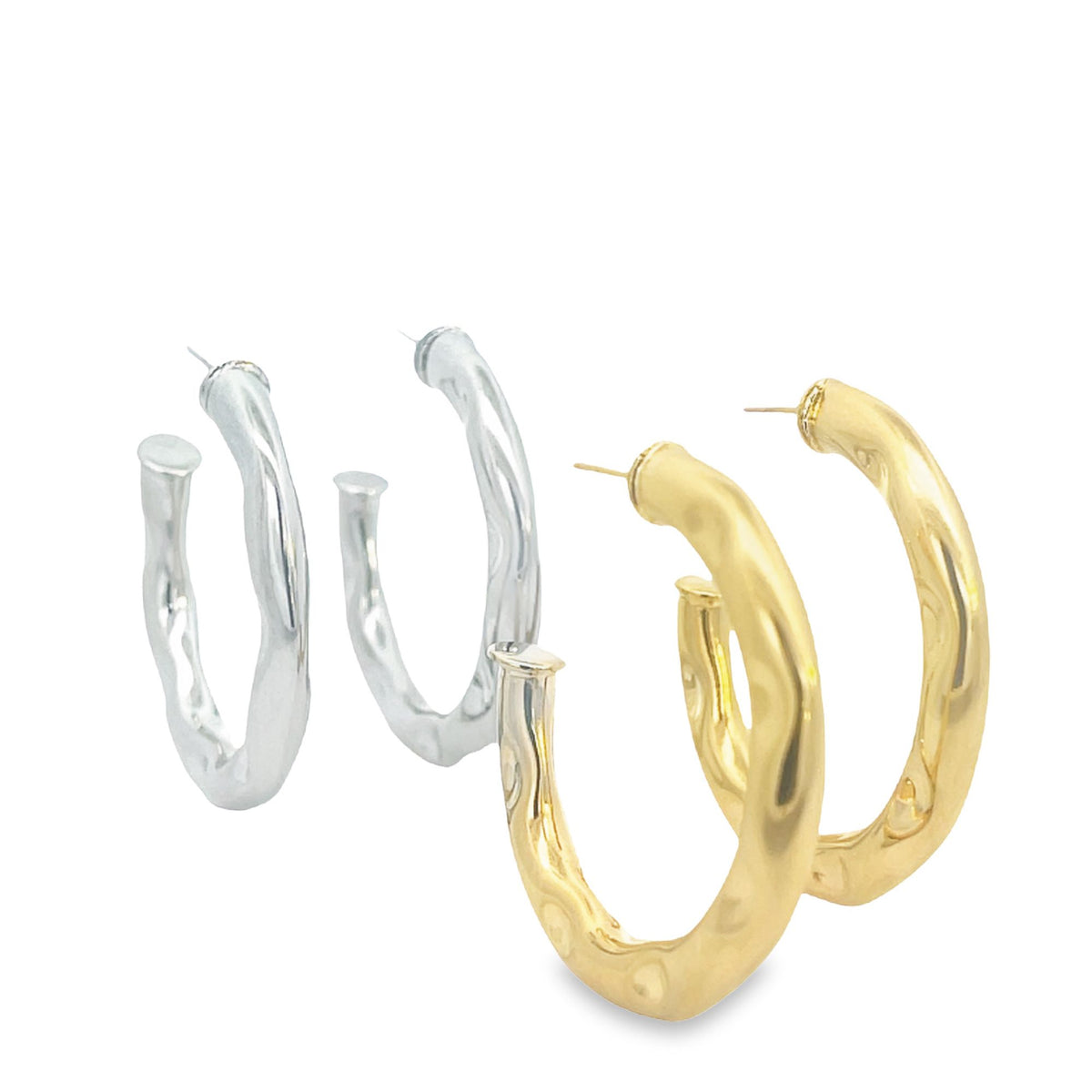 Two pairs of textured metal hoop earrings display a sleek silver set alongside a polished gold set against a clean white background.
