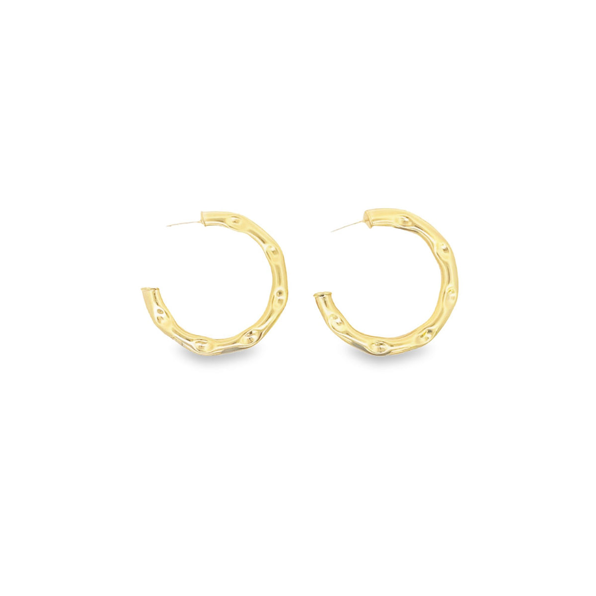 A pair of textured gold hoop earrings rests against a clean white background.
