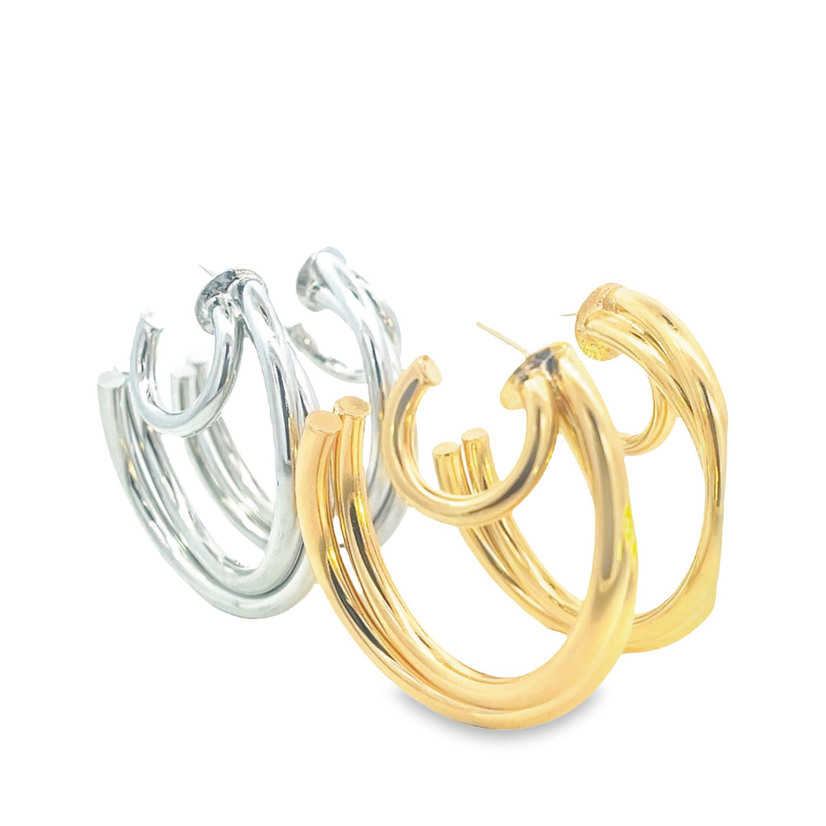 A pair of multi-layered silver and gold hoop earrings gleams against a clean white background.