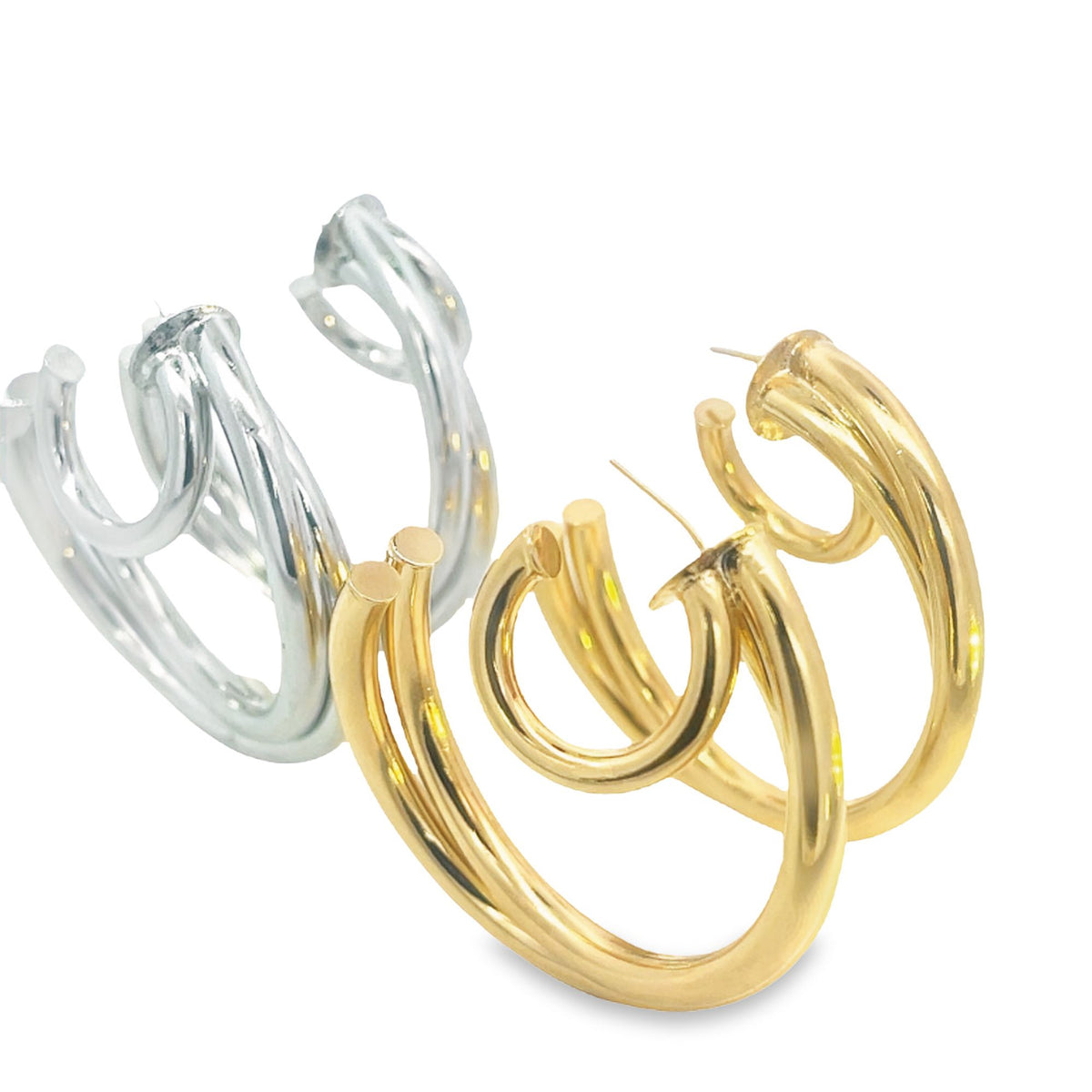 Two pairs of chunky, multi-band gold and silver hoop earrings rest against a clean white background.