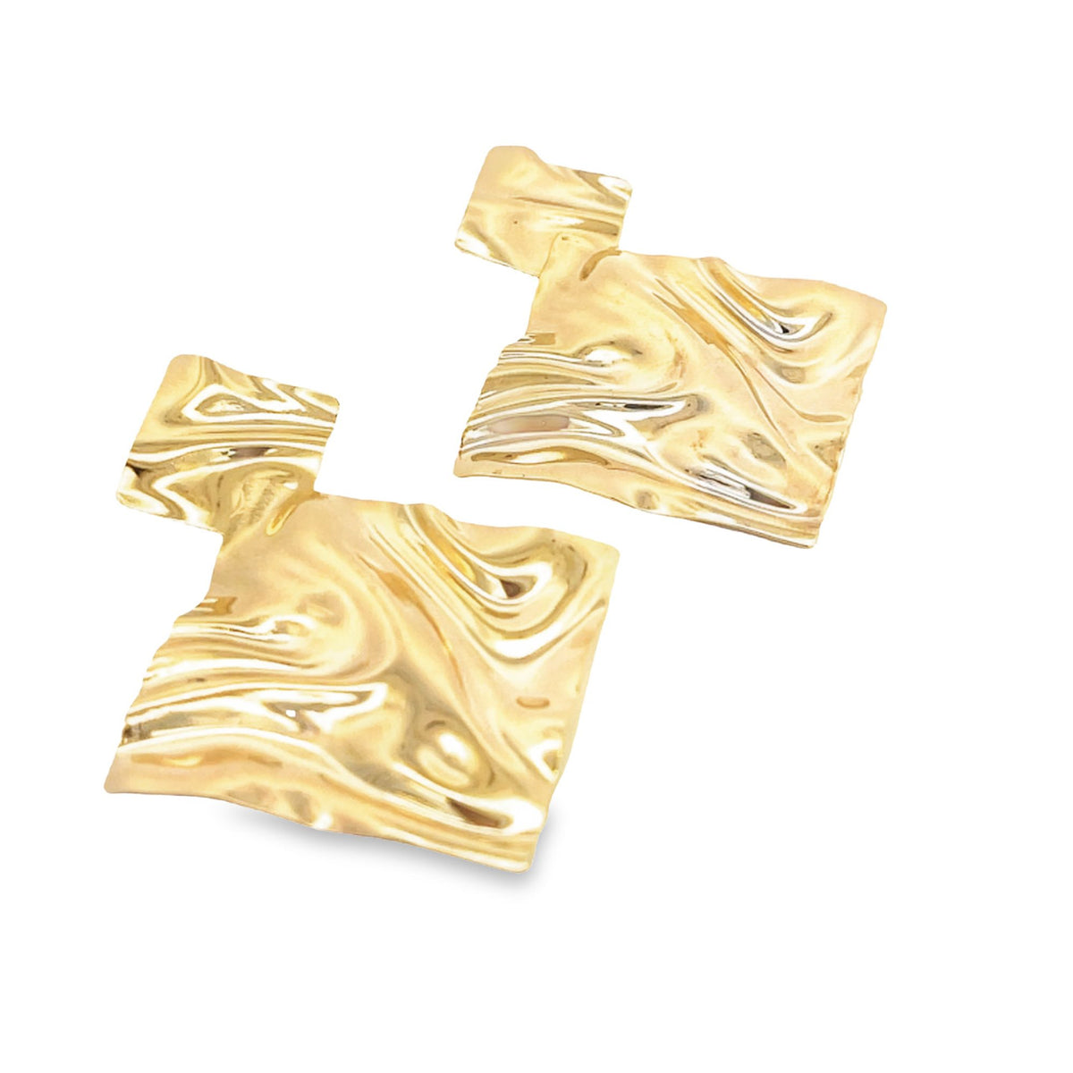 A pair of geometric gold earrings with a rippled, melting texture rests against a white background.
