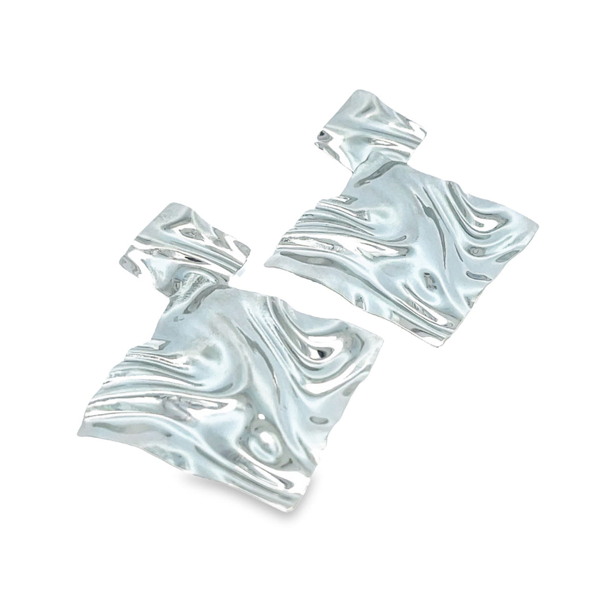 A pair of statement earrings features abstract, rippled silver metal squares dangling against a white background.
