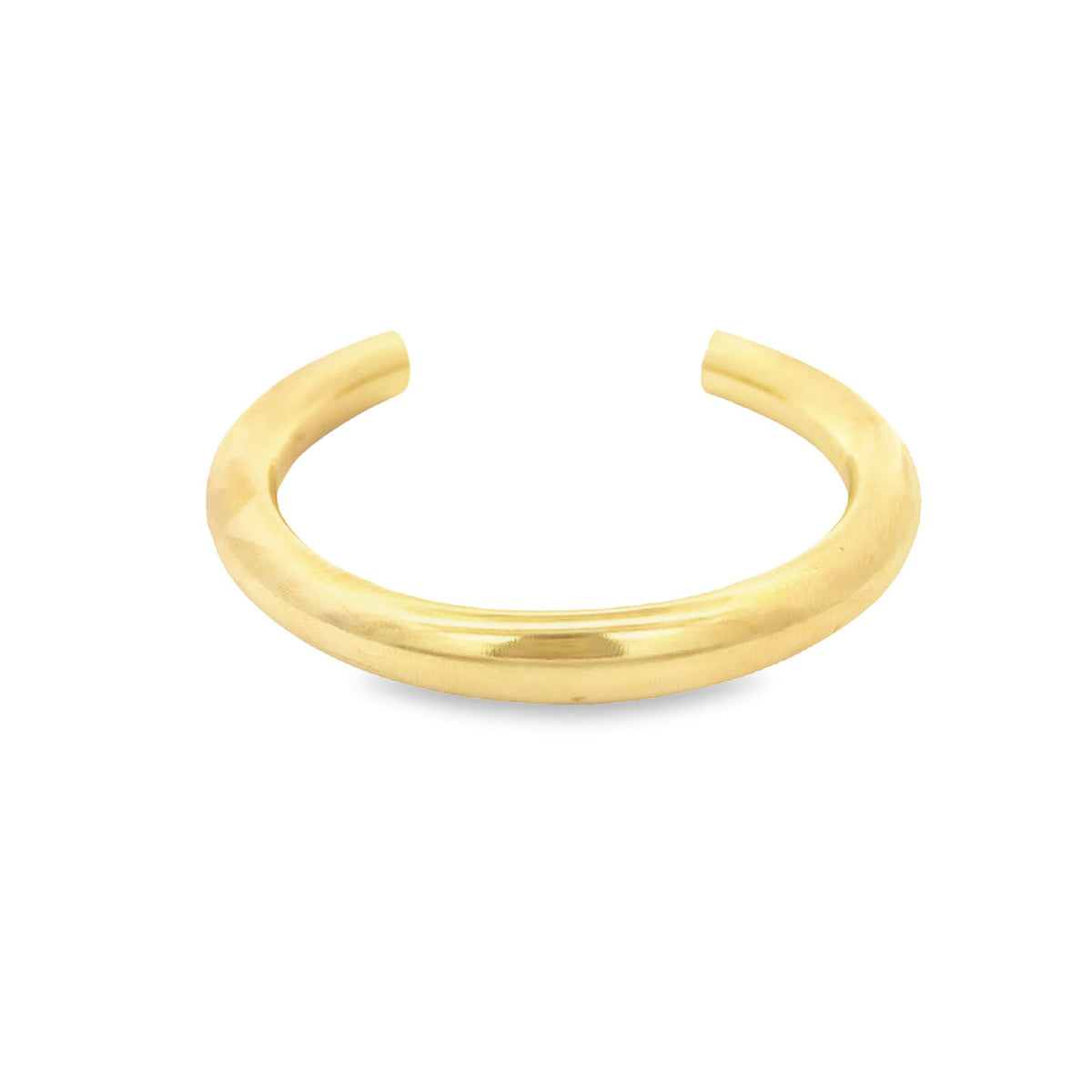A minimalist gold cuff ring rests on a clean white background.
