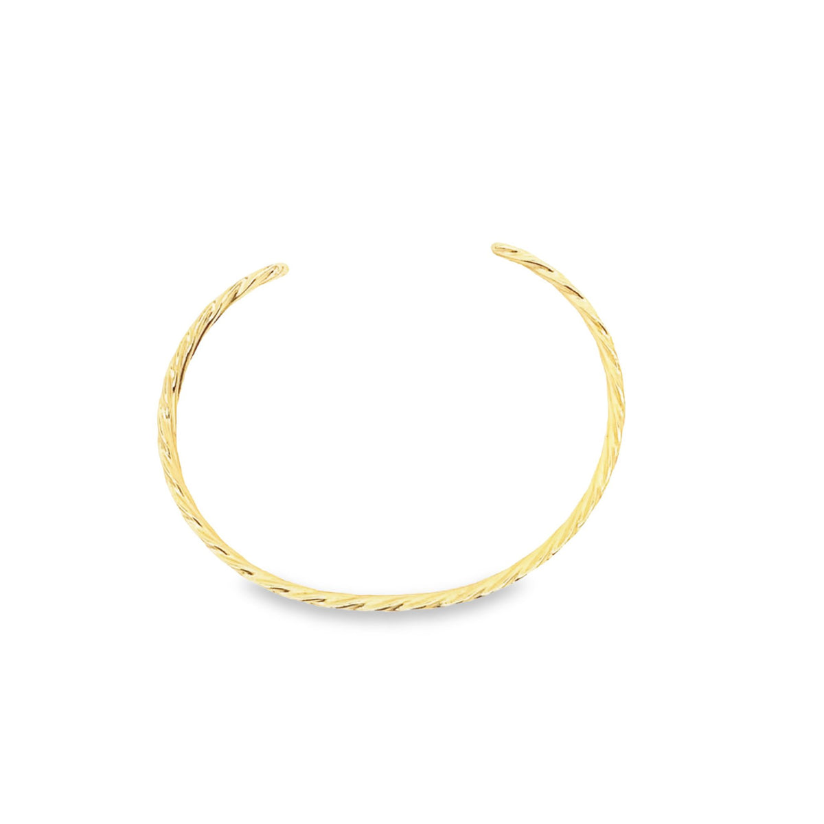 A sleek gold cuff bracelet rests on a white background, showcasing a delicate twisted design.