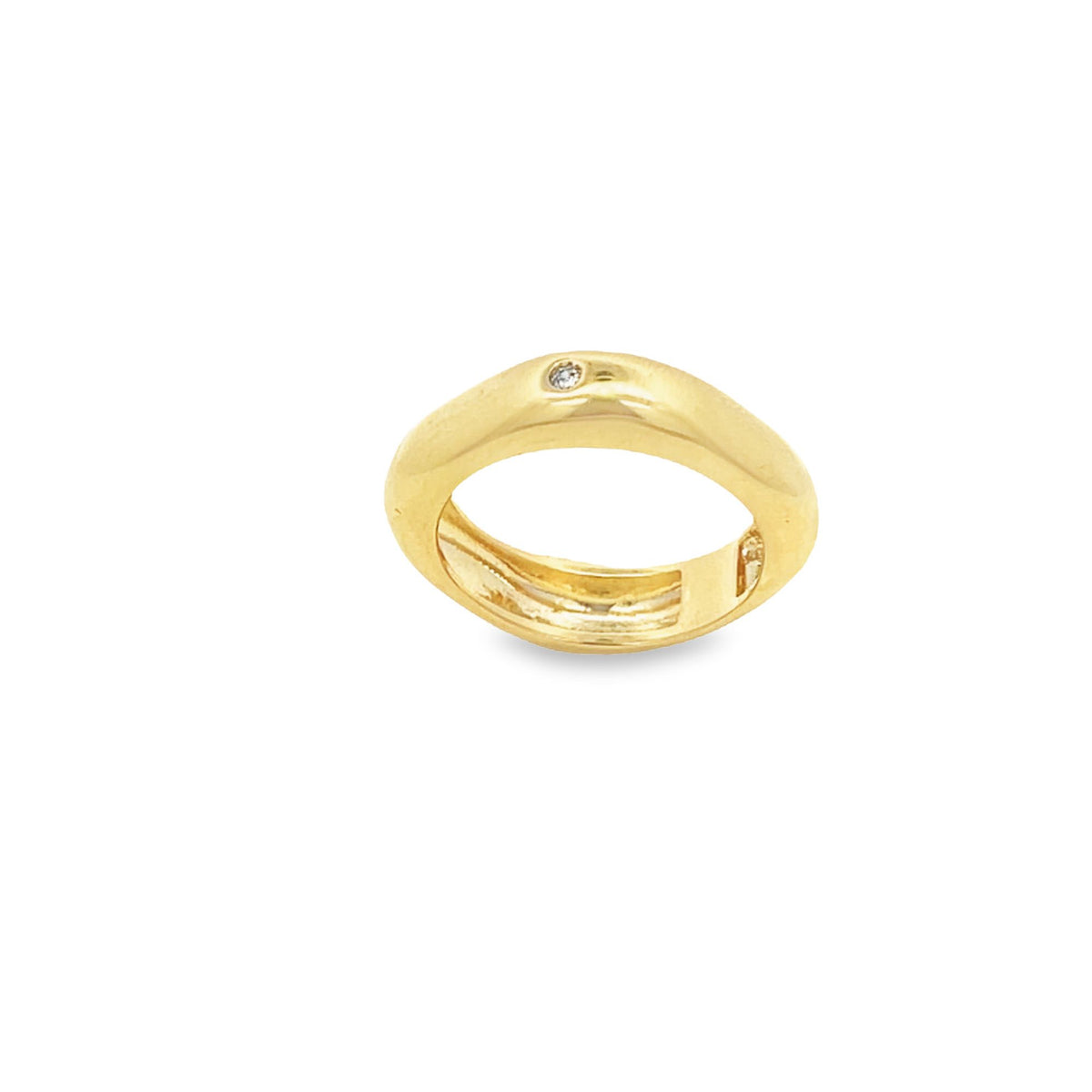 A sleek gold ring features a single flush-set diamond sparkling on its polished surface against a clean white background.