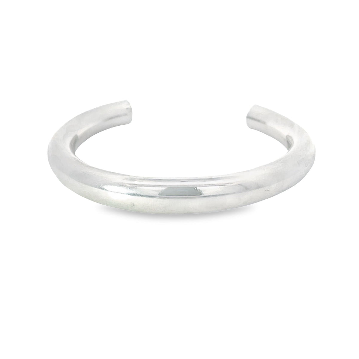 A thick, polished sterling silver cuff bracelet rests against a clean white background.