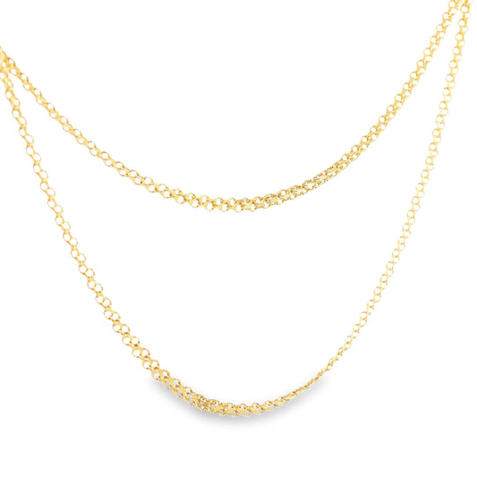A delicate layered gold chain necklace sparkles against a clean white background.