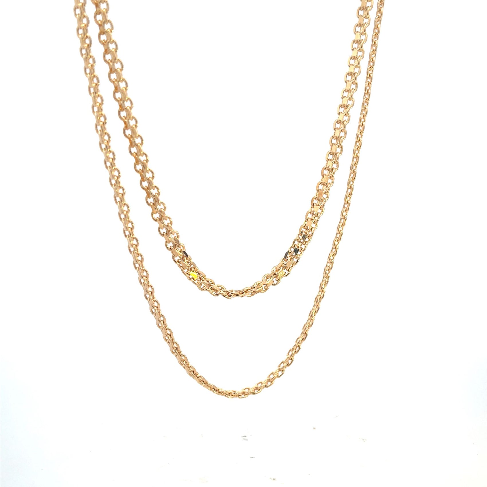 Two delicate gold chain necklaces hang gracefully against a plain white background.