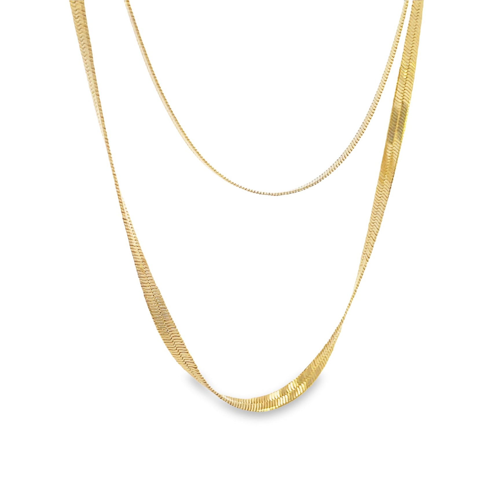 Two layered gold chain necklaces hang delicately against a plain white background.