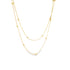 A delicate double-layered gold chain necklace features evenly spaced spherical beads along its thin links against a plain white background.