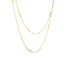 Two delicate gold chain necklaces with textured geometric links drape gracefully against a white background.