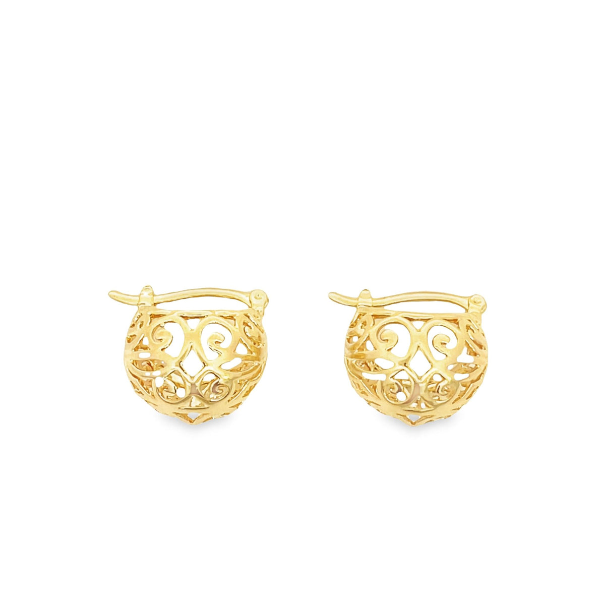 A pair of gold filigree huggie earrings rests on a clean white background.