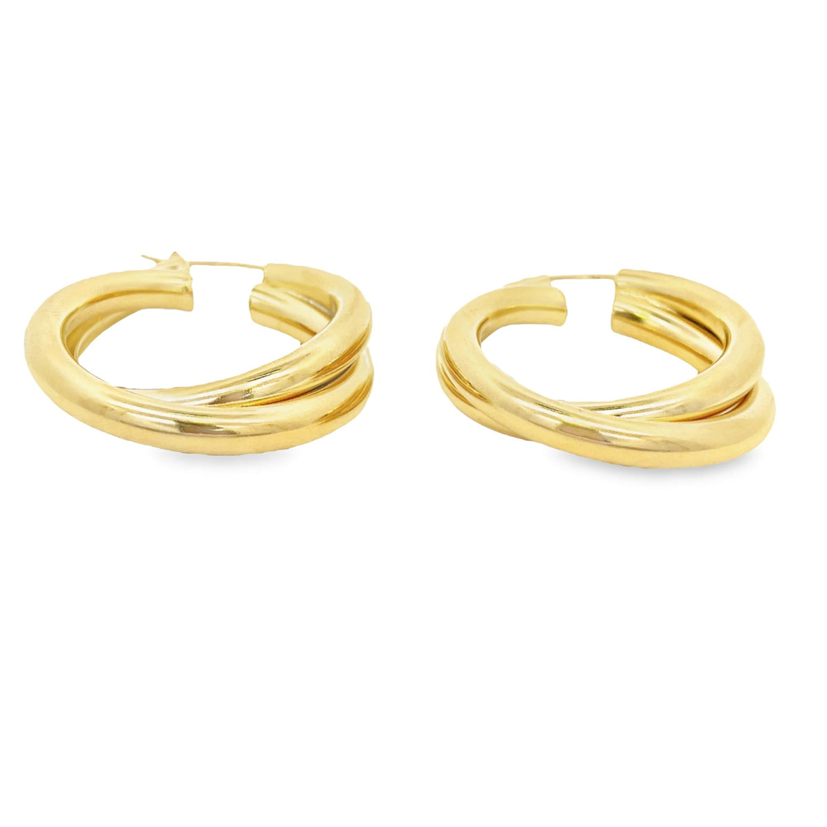 A pair of thick gold interlocking hoop earrings rests against a clean white background.