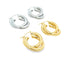 Two pairs of chunky, interlocking double hoop earrings rest against a white background, featuring polished silver and gold finishes.