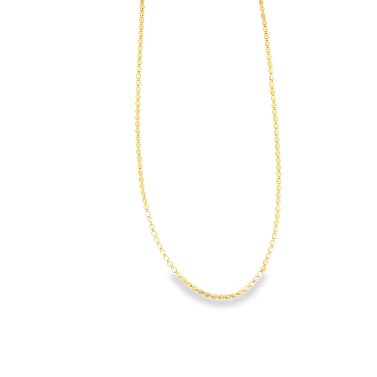 A delicate gold coin chain necklace hangs against a clean white background.