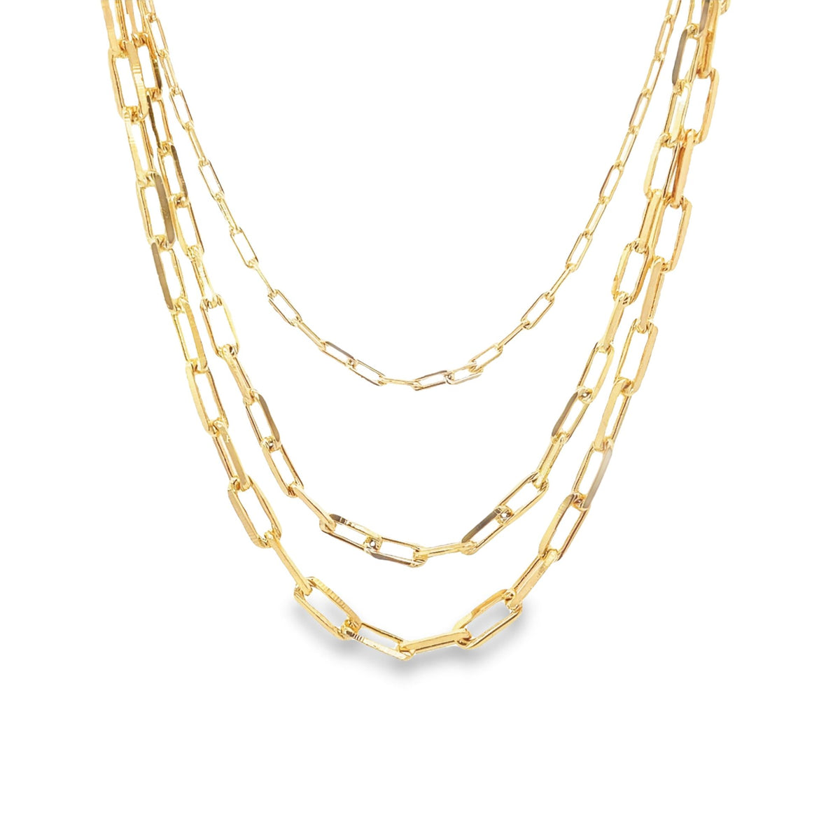 A layered gold paperclip chain necklace drapes elegantly against a white background.