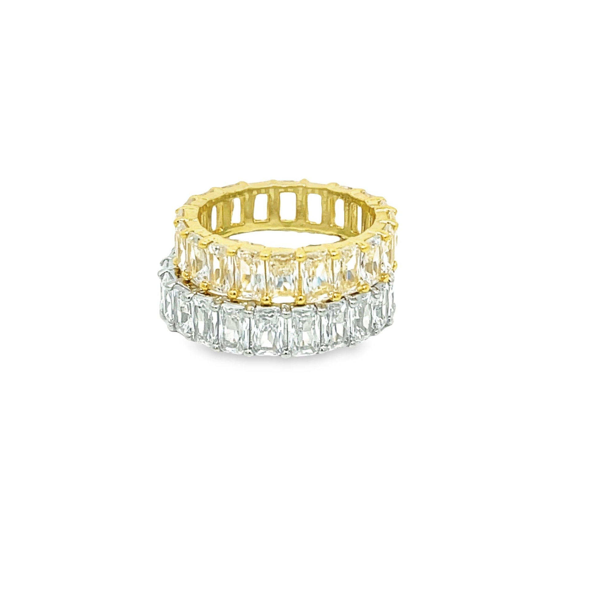 Two stacked eternity bands feature a row of yellow emerald-cut stones in gold and a row of clear emerald-cut stones in silver.